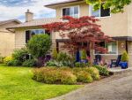 The front entrance of a house with a circular garden bed